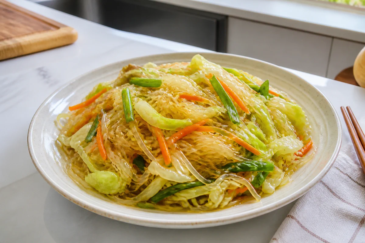 Cabbage glass noodle stir-fry with carrot, green onion, and glossy soy garlic sauce