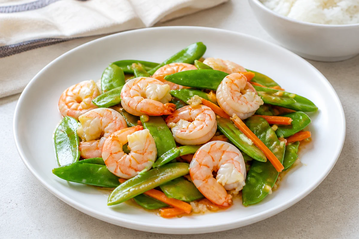 Shrimp snow pea stir-fry with carrots and white rice